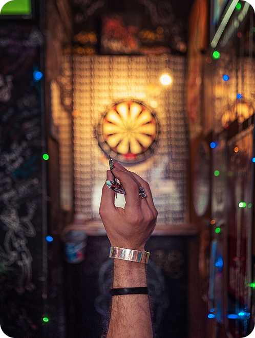 Hands stacked together on a tree branch
